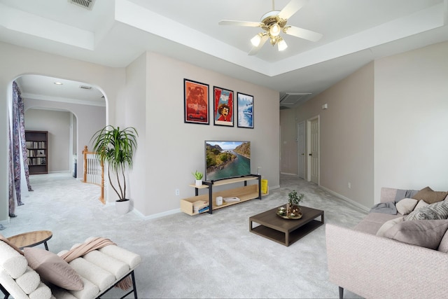 2130 White Eagle Ln, Katy, TX 77450 - carpeted living area featuring arched walkways, ceiling fan, baseboards, and a raised ceiling