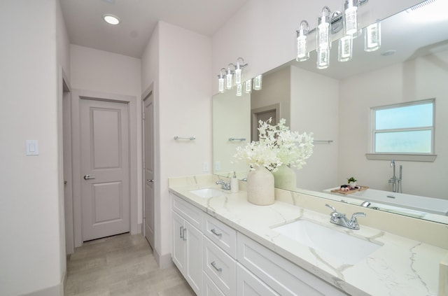 full bathroom featuring double vanity, baseboards, and recessed lighting