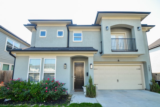 view of front of property with a balcony, stucco siding, and a garage