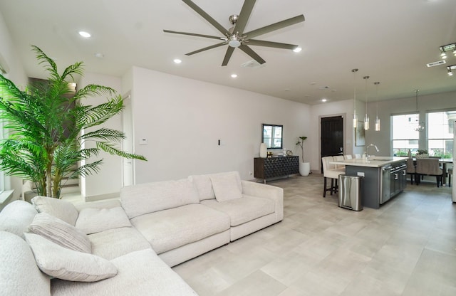 living area featuring ceiling fan and recessed lighting