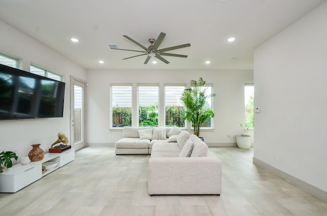 living room featuring ceiling fan, recessed lighting, and baseboards