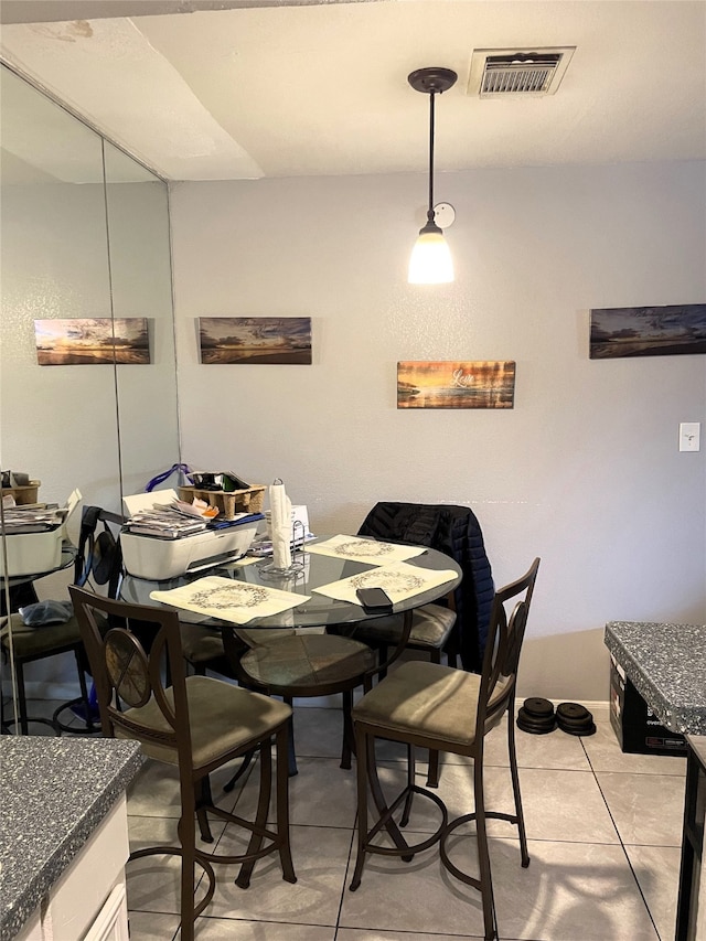 dining area with light tile patterned flooring