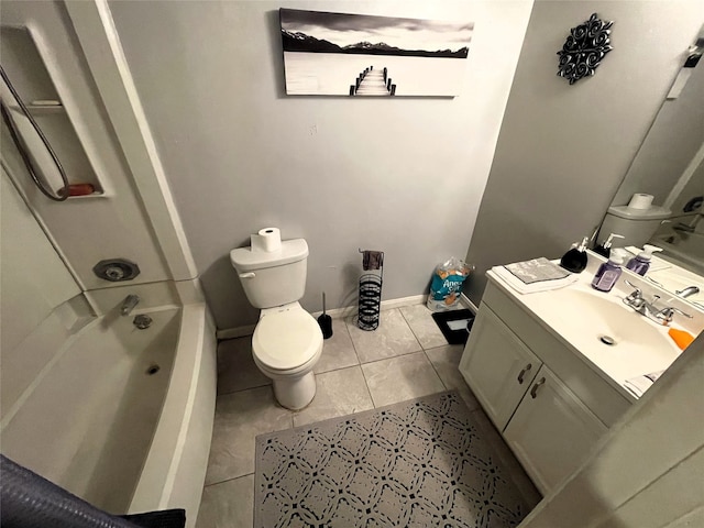 bathroom featuring toilet, vanity, tile patterned flooring, baseboards, and shower / washtub combination