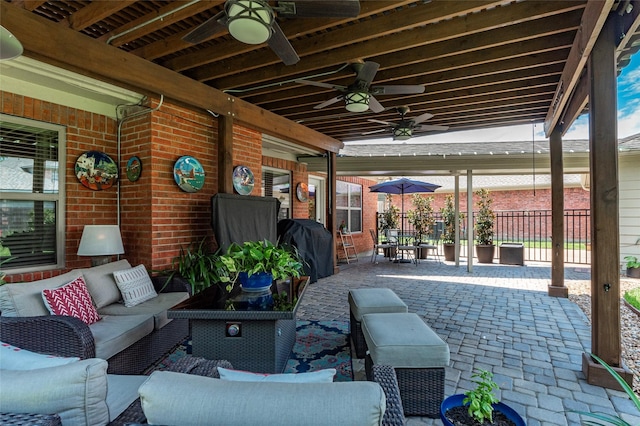 view of patio featuring an outdoor living space, ceiling fan, fence, and area for grilling