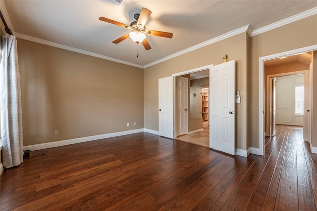 unfurnished bedroom featuring dark wood finished floors, ornamental molding, baseboards, and a ceiling fan