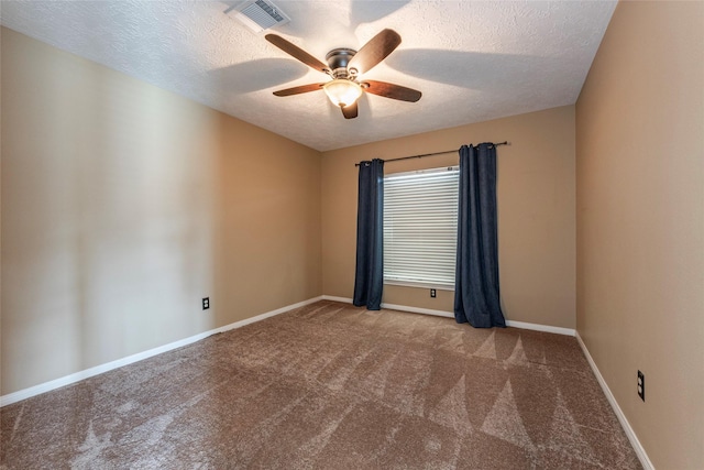 carpeted empty room featuring a ceiling fan, a textured ceiling, and baseboards