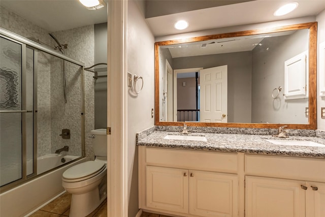full bath with toilet, double vanity, enclosed tub / shower combo, tile patterned flooring, and recessed lighting