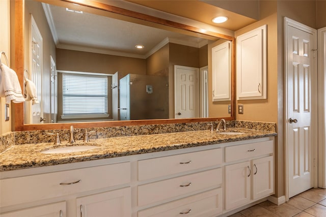 full bath featuring a shower stall, ornamental molding, tile patterned flooring, and double vanity