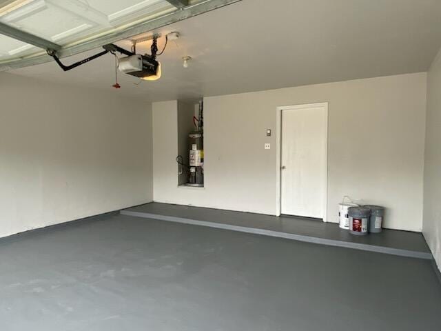 garage featuring water heater and a garage door opener