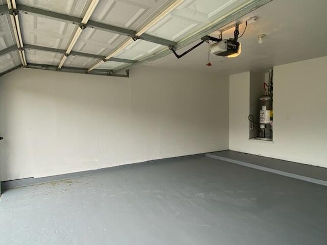 garage featuring a garage door opener and secured water heater