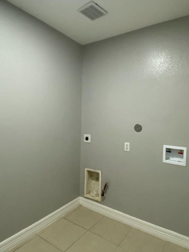 laundry room with hookup for an electric dryer, hookup for a washing machine, light tile patterned floors, and baseboards
