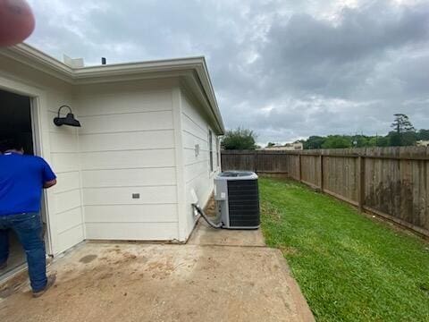 view of side of home with central AC unit