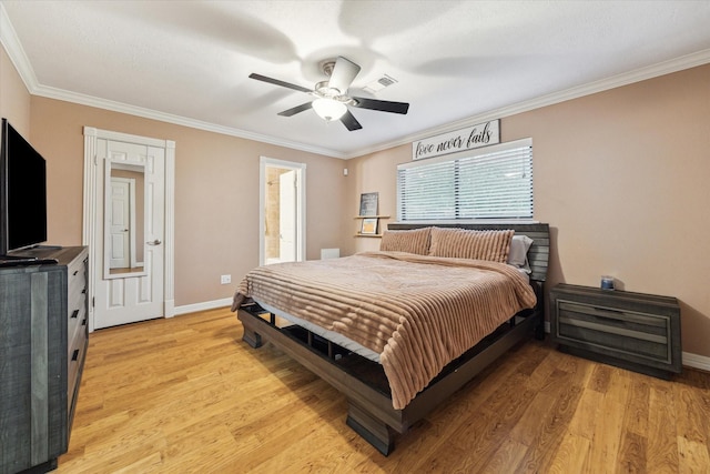 bedroom featuring crown molding, light wood-type flooring, baseboards, a ceiling fan, and ensuite bath