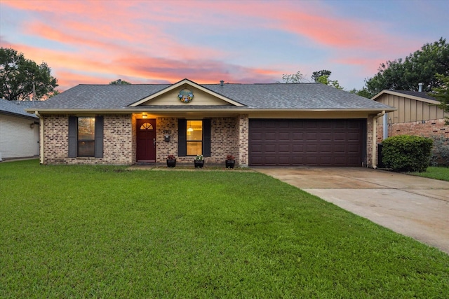 ranch-style house featuring driveway, an attached garage, a front lawn, and brick siding