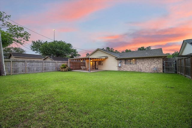back of house at dusk with a patio area