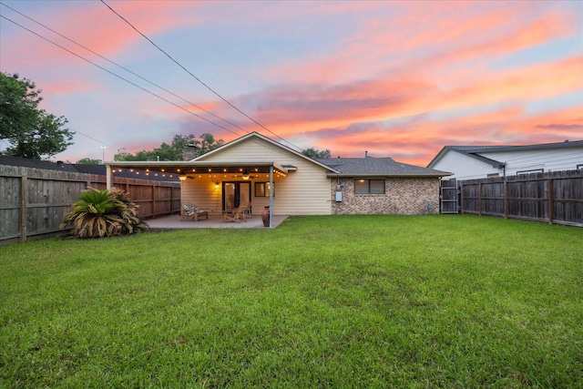 back of property at dusk with a patio and a ceiling fan