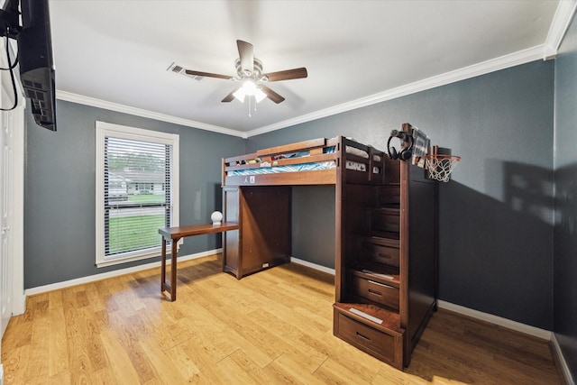 unfurnished bedroom featuring wood finished floors, ornamental molding, baseboards, and ceiling fan