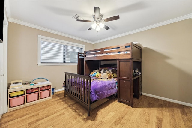 bedroom with light wood finished floors, crown molding, baseboards, and a ceiling fan