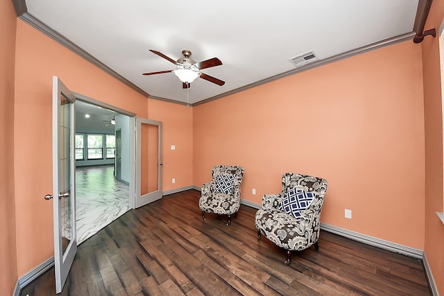 living area featuring a ceiling fan, crown molding, wood finished floors, and baseboards