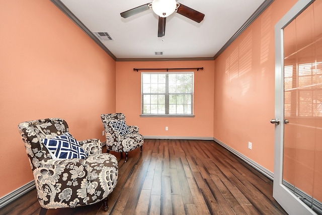 sitting room with crown molding, wood-type flooring, ceiling fan, and baseboards
