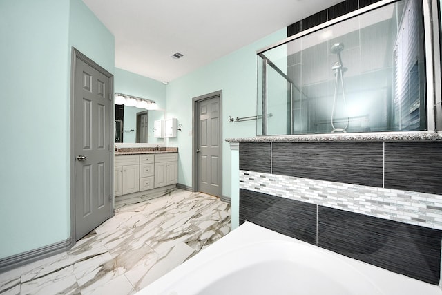 full bathroom featuring a stall shower, vanity, marble finish floors, and a bathtub