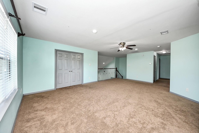 carpeted empty room with baseboards, a ceiling fan, and recessed lighting