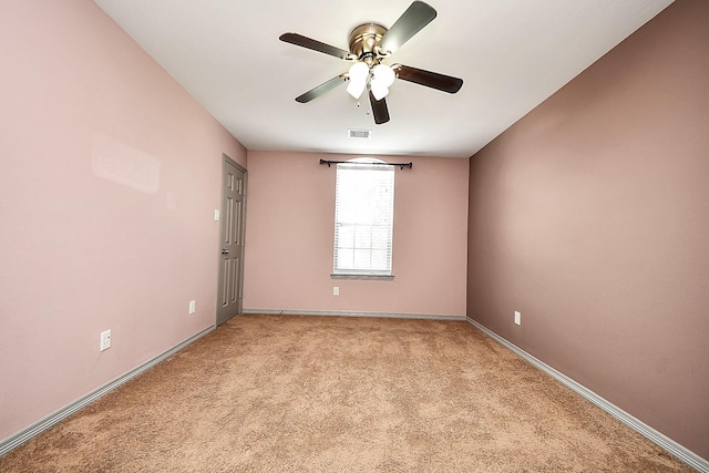 unfurnished room featuring a ceiling fan, light colored carpet, and baseboards