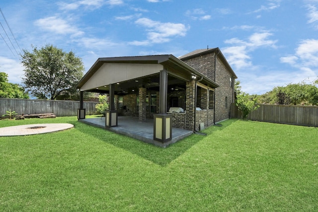 view of yard featuring an outdoor fire pit and a patio