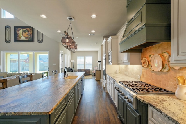 6919 Champion Trl, Katy, TX 77493 - kitchen featuring open floor plan, a sink, premium range hood, dark wood-type flooring, and recessed lighting