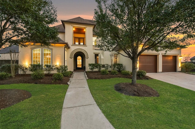 6919 Champion Trl, Katy, TX 77493 - mediterranean / spanish home featuring stucco siding, driveway, a front lawn, and a garage