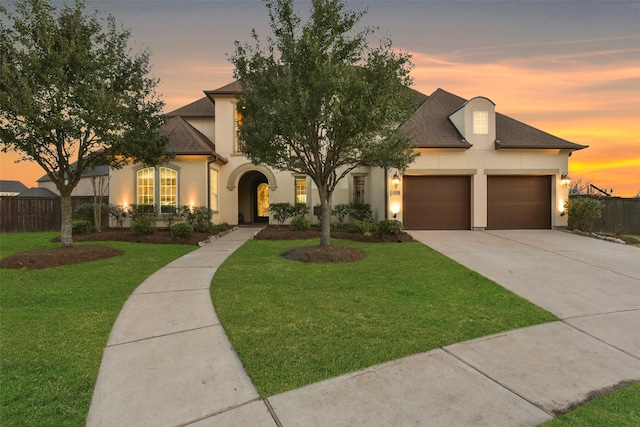 6919 Champion Trl, Katy, TX 77493 - view of front facade with stucco siding, driveway, an attached garage, and a shingled roof