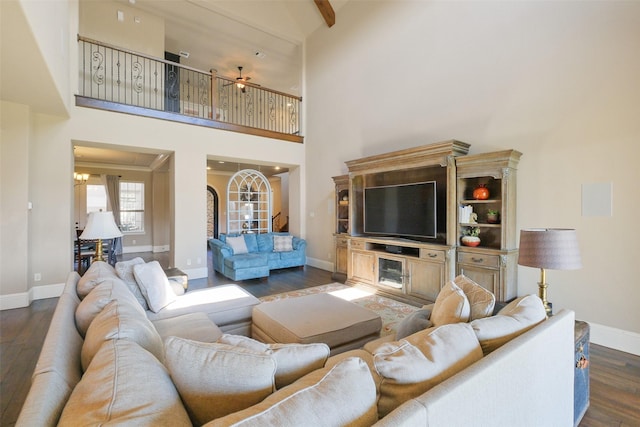 6919 Champion Trl, Katy, TX 77493 - living room with a towering ceiling, baseboards, dark wood-style floors, a chandelier, and ceiling fan