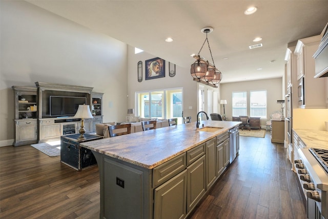 6919 Champion Trl, Katy, TX 77493 - kitchen featuring a sink, open floor plan, stove, dark wood-type flooring, and recessed lighting