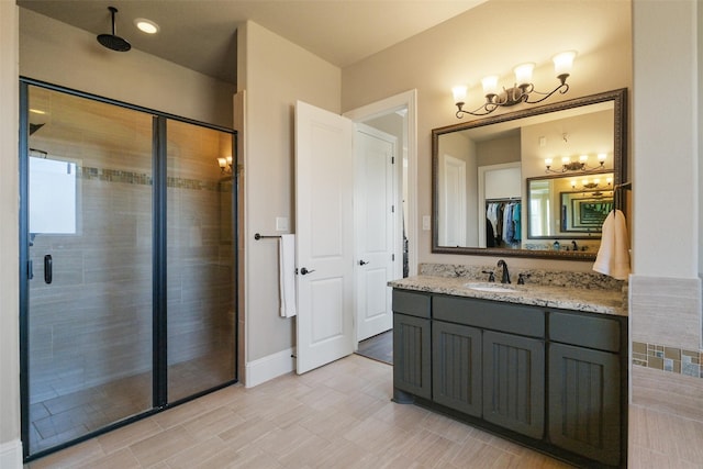 6919 Champion Trl, Katy, TX 77493 - bathroom with a chandelier, a shower stall, vanity, and baseboards
