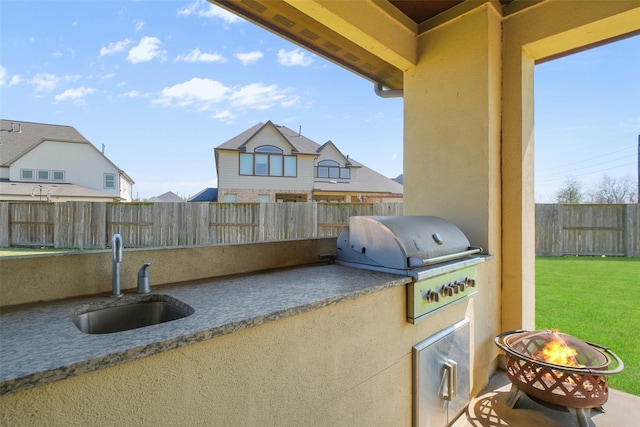 6919 Champion Trl, Katy, TX 77493 - view of patio with area for grilling, a sink, a fire pit, and an outdoor kitchen