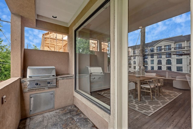 balcony featuring area for grilling and an outdoor kitchen