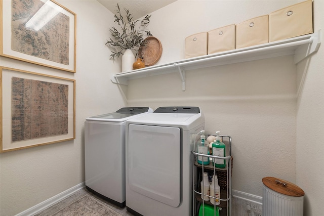 20710 Kings Timber Trl, Humble, TX 77346 - laundry room with washer and dryer, baseboards, and wood finished floors