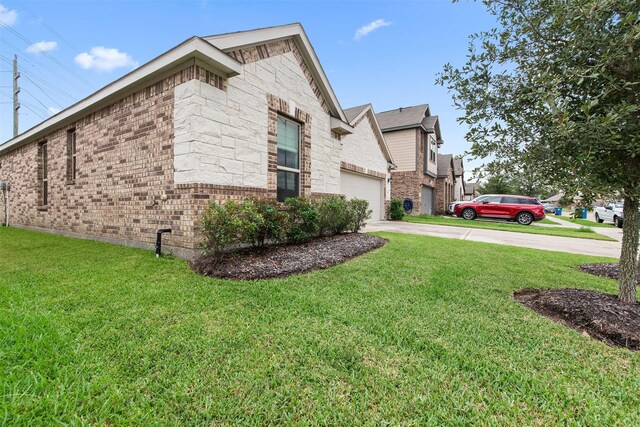 20710 Kings Timber Trl, Humble, TX 77346 - view of side of home with driveway, a lawn, brick siding, and an attached garage