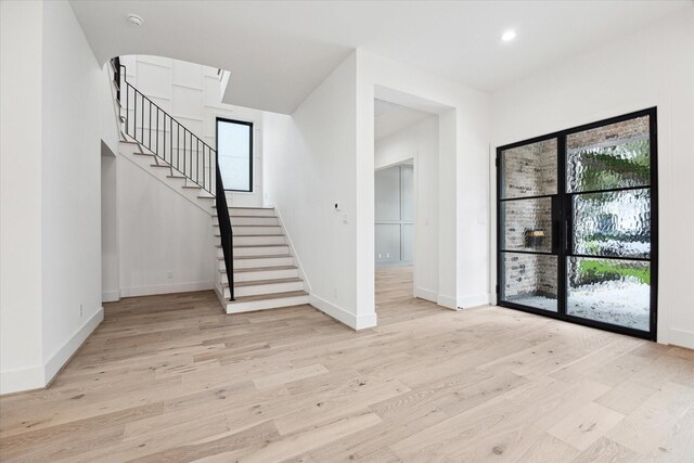 4706 Waring St, Houston, TX 77027 - foyer with stairway, light wood-type flooring, baseboards, and recessed lighting