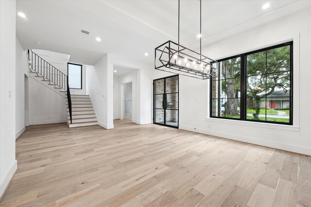 4706 Waring St, Houston, TX 77027 - unfurnished dining area featuring recessed lighting, stairway, baseboards, light wood-type flooring, and a chandelier