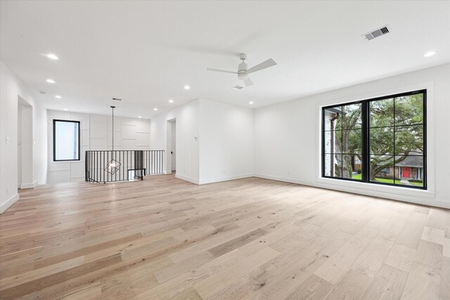 4706 Waring St, Houston, TX 77027 - unfurnished living room with light wood-style flooring, a ceiling fan, recessed lighting, and baseboards