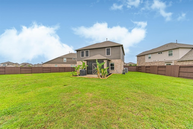 12750 Tullich Ln, Humble, TX 77346 - rear view of house featuring a sunroom, brick siding, and central air condition unit