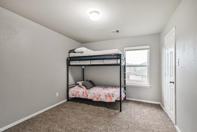 12750 Tullich Ln, Humble, TX 77346 - bedroom with carpet, baseboards, and a textured ceiling