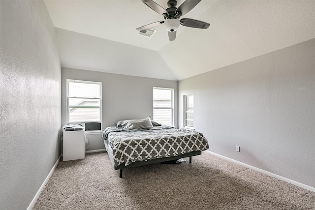 12750 Tullich Ln, Humble, TX 77346 - carpeted bedroom featuring multiple windows, baseboards, vaulted ceiling, and ceiling fan