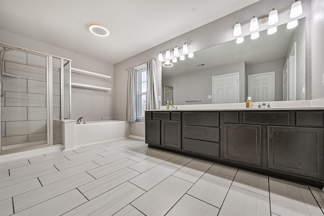 12750 Tullich Ln, Humble, TX 77346 - full bathroom with a shower stall, a bath, double vanity, and baseboards