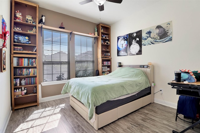 27163 Allenby Park Dr, Magnolia, TX 77354 - bedroom with wood finished floors, baseboards, and ceiling fan