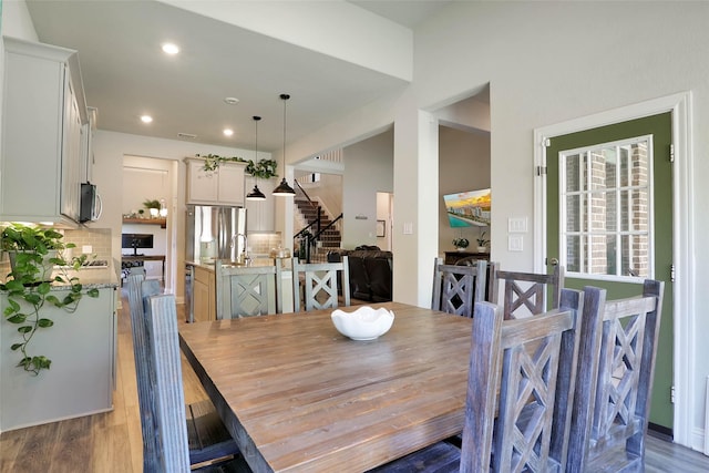 27163 Allenby Park Dr, Magnolia, TX 77354 - dining room featuring stairway, light wood finished floors, and recessed lighting