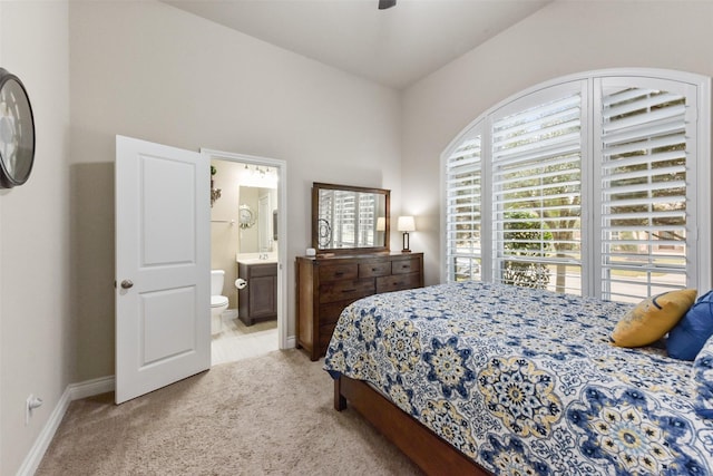 19914 Philippa Hills Trl, Cypress, TX 77433 - bedroom with light carpet, baseboards, and ensuite bathroom