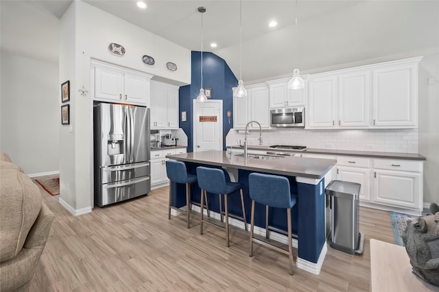 17214 Sequoia Kings Dr, Humble, TX 77346 - kitchen featuring stainless steel appliances, a sink, baseboards, tasteful backsplash, and high vaulted ceiling
