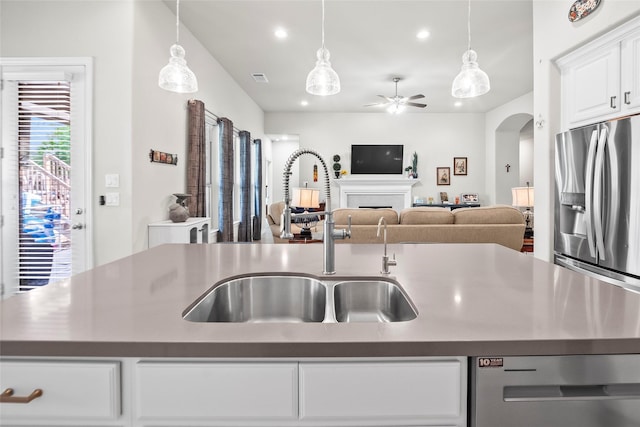 17214 Sequoia Kings Dr, Humble, TX 77346 - kitchen with a sink, stainless steel appliances, open floor plan, recessed lighting, and arched walkways
